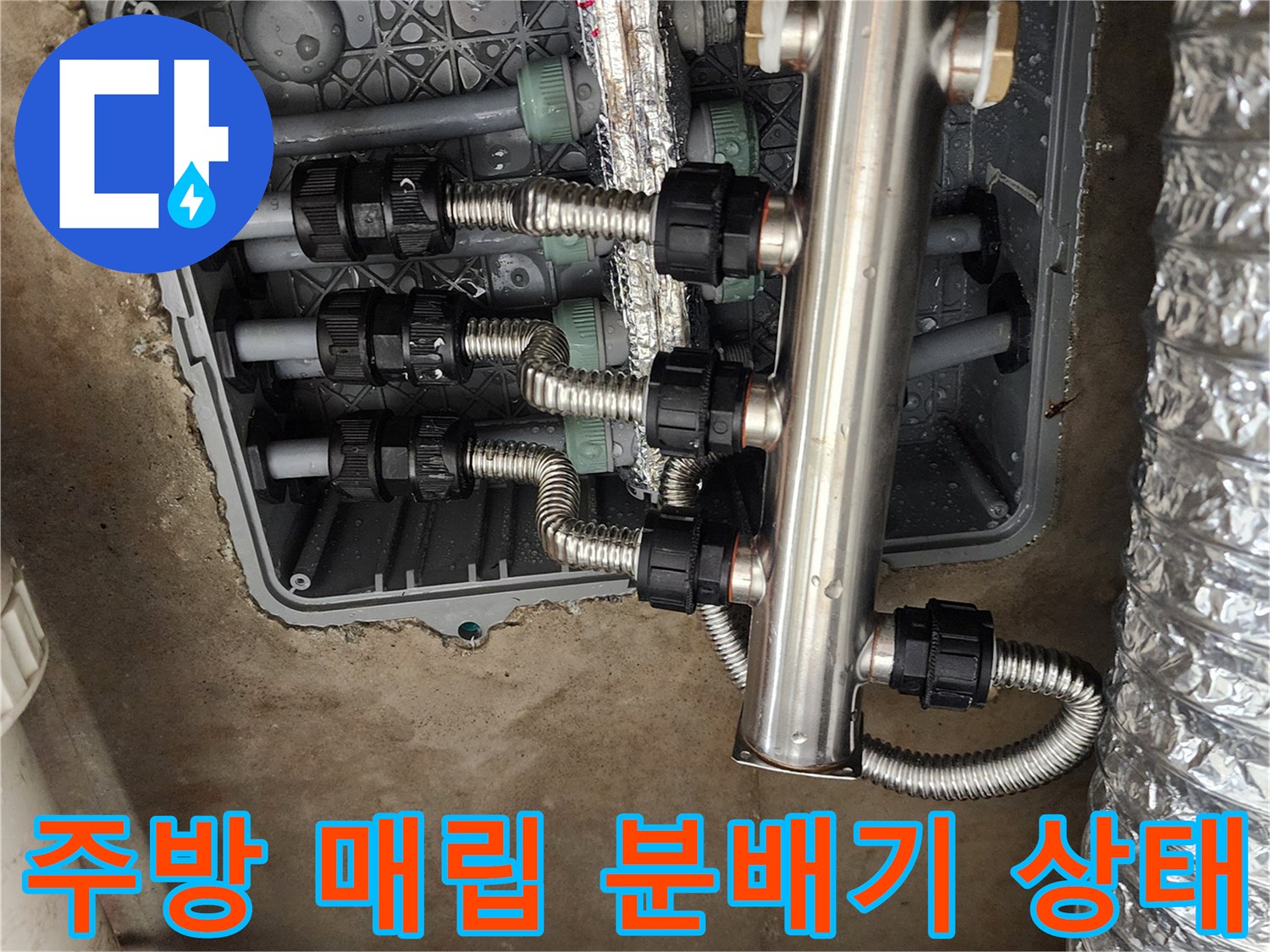 주방 싱크대 하단-매립된 스테인리스 분배기와 배관 연결 부위 모습
