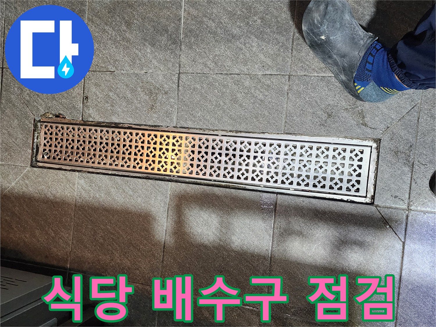 금속제 배수 트렌치와 주변 타일 바닥의 모습
