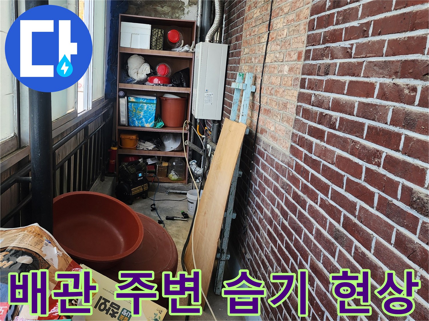 습기가 관찰되는 붉은 벽돌 외벽과 노출된 배관의 모습