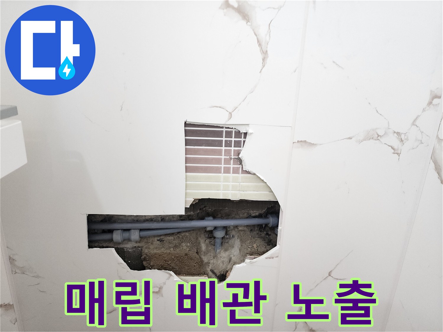벽면-타일을-제거한-후-드러난-회색-배관의-연결부
