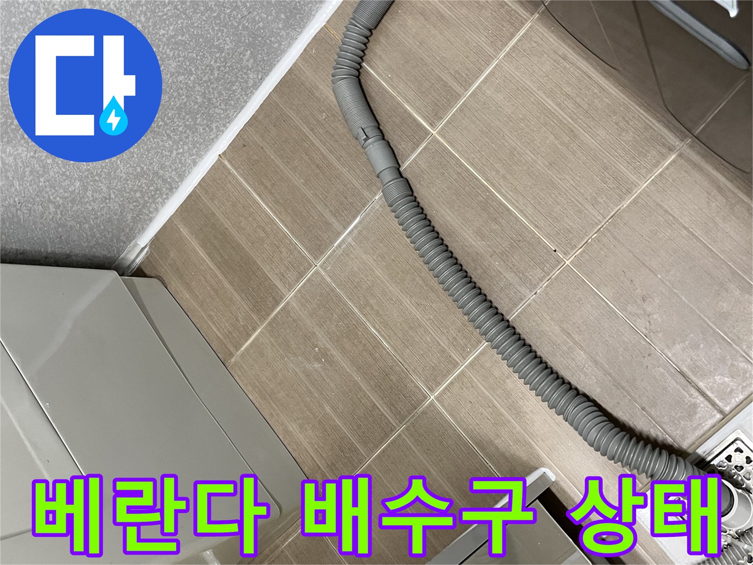 세탁기 배수 호스가 연결된 베란다 타일 바닥 모습