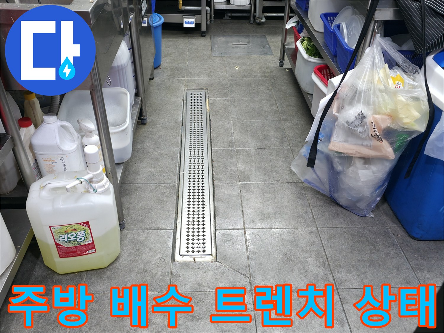 상가 주방 바닥에 설치된 스테인리스 배수 트렌치와 주변 타일 모습