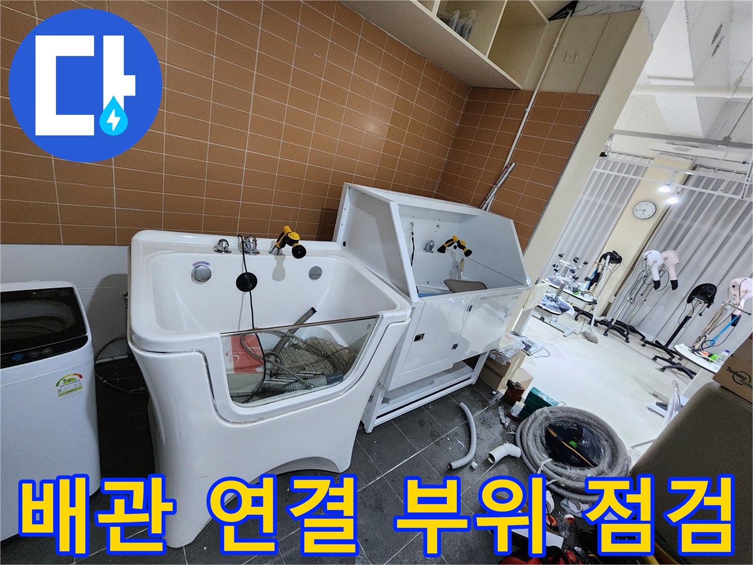 샴푸대 근처-배관 연결부의 누수 흔적을 조사하는 현장 사진입니다.