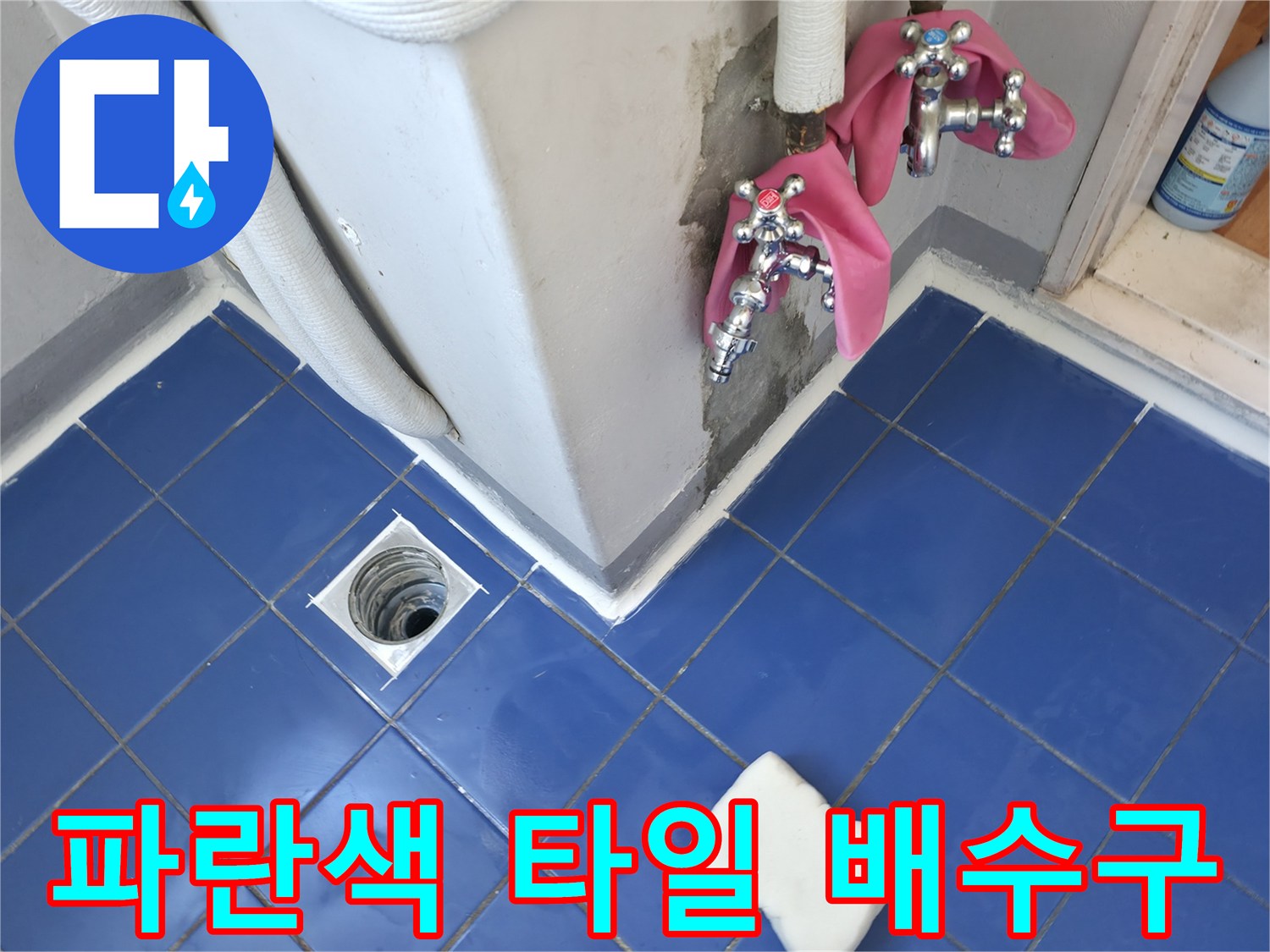 세탁실 바닥의 파란 타일과 하수구 유가