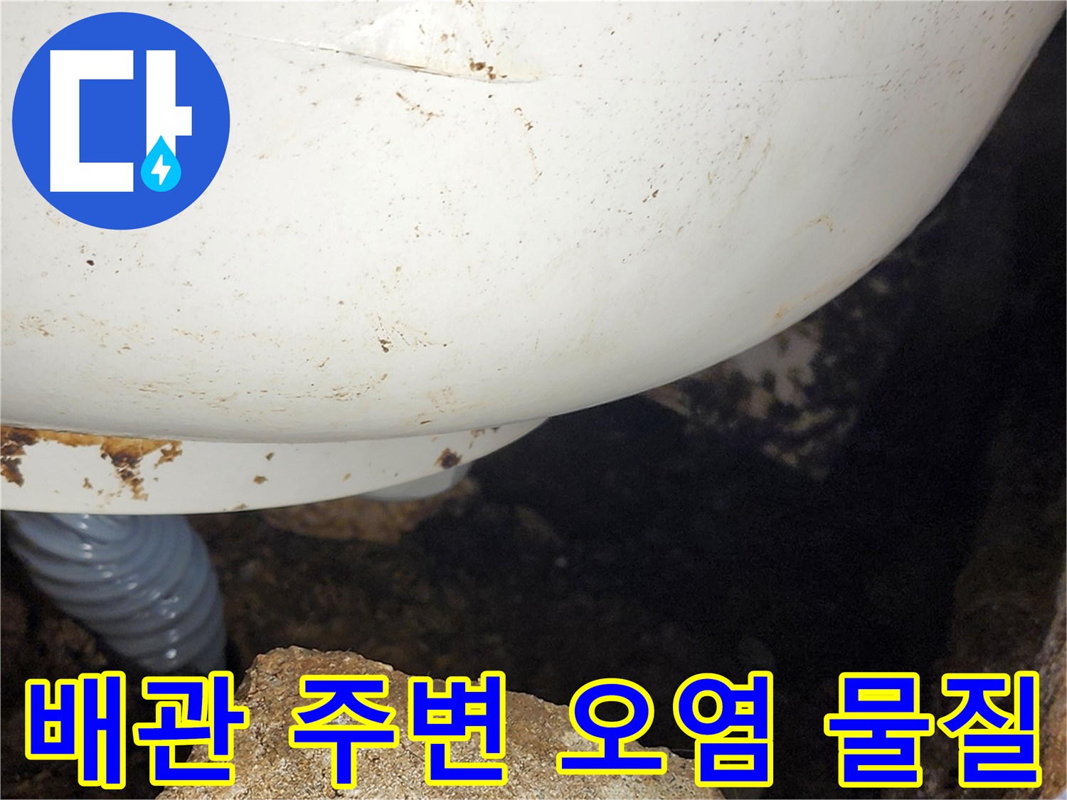 하얀색 배관과 회색 유연 호스 사이의 흙 퇴적물