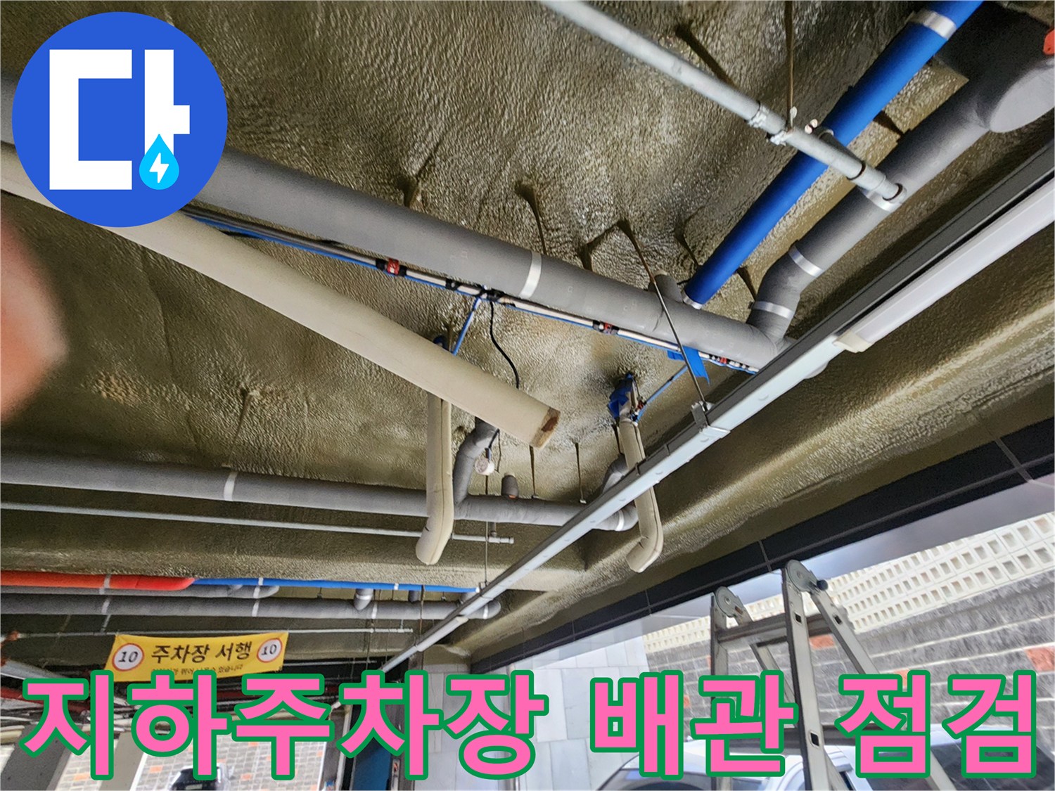 지하주차장 천장에 설치된 복잡한 배관 시스템의 상태 확인