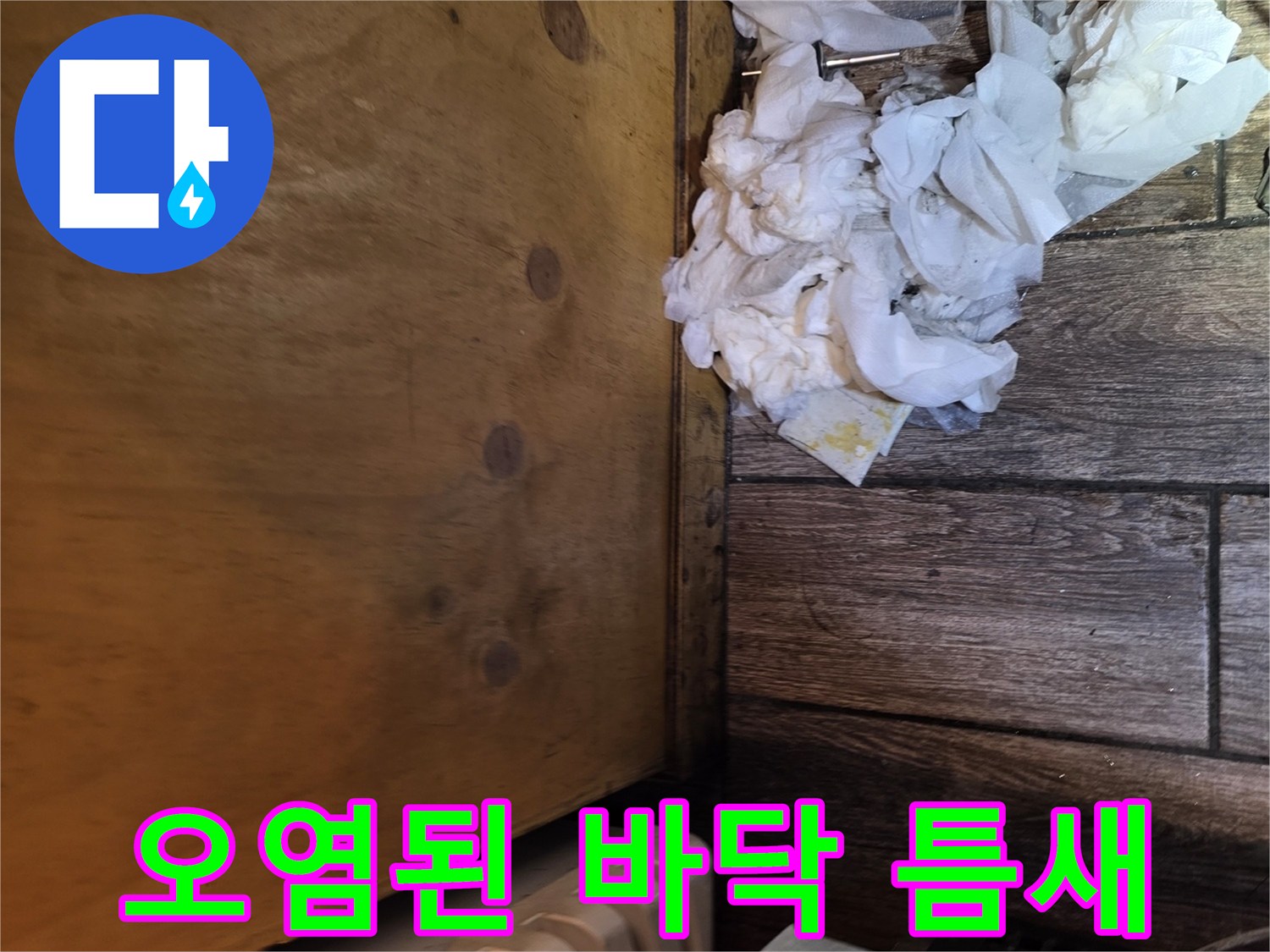 나무 마감재 하단과 오염물이 묻은 듯한 바닥 자재