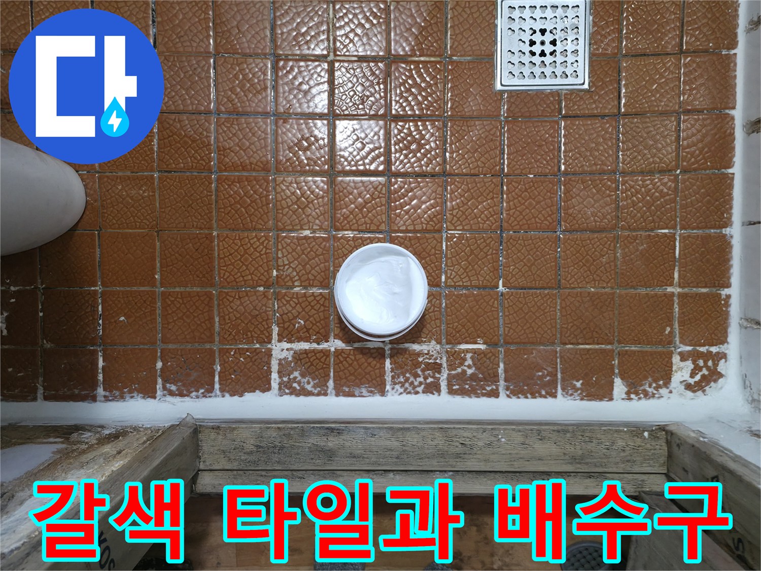 욕실 바닥의 갈색 타일 - 하얀색 배수구와 배관 입구