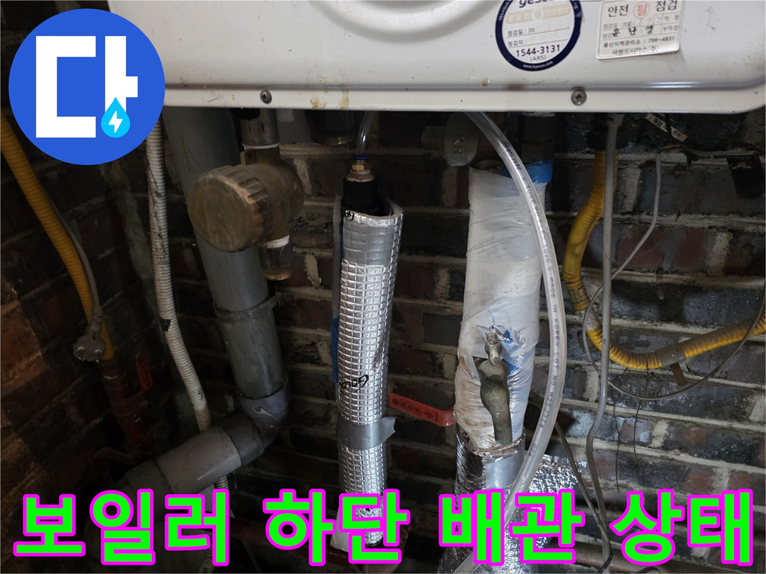 은색 테이핑과-보온재로 마감된 보일러 하부 배관