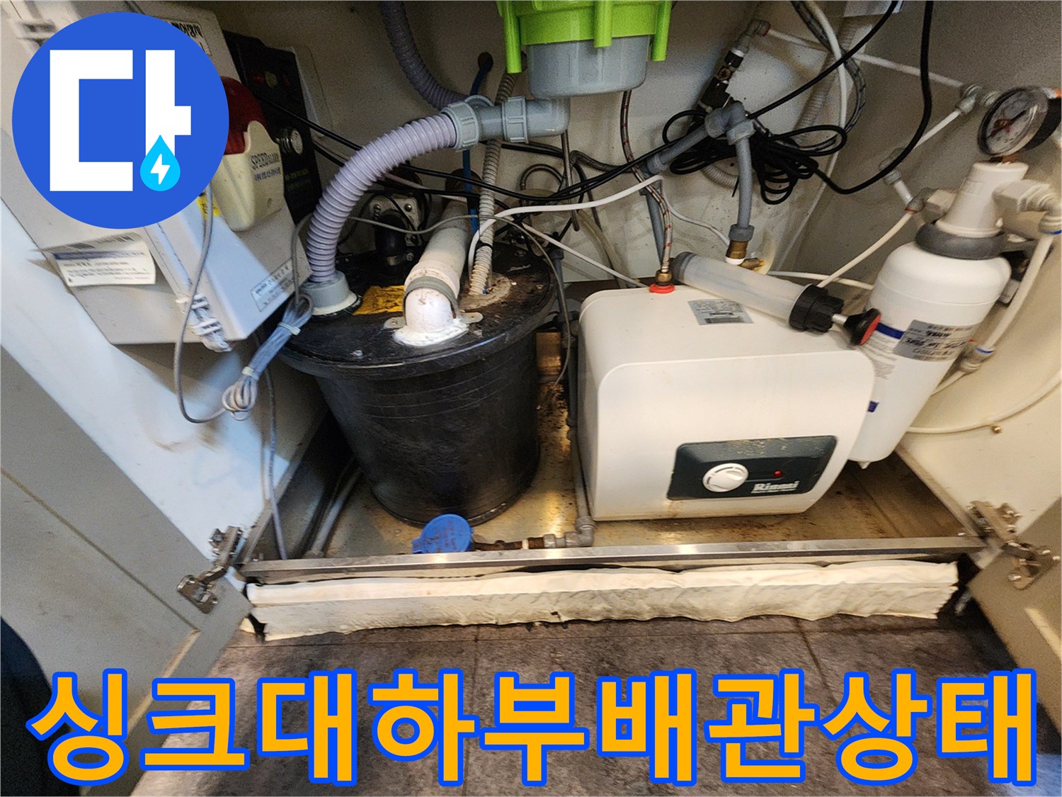 서초구 싱크대 하단부 복잡한 배관과 온수기 설비 모습
