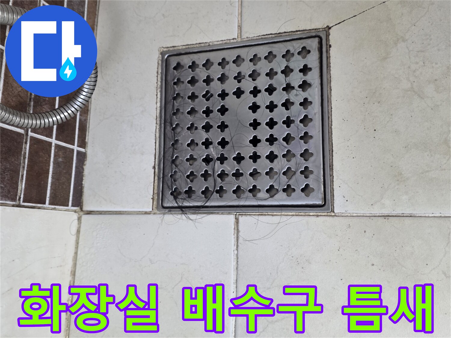 화장실 배수구 주변 타일의 파손된 모습