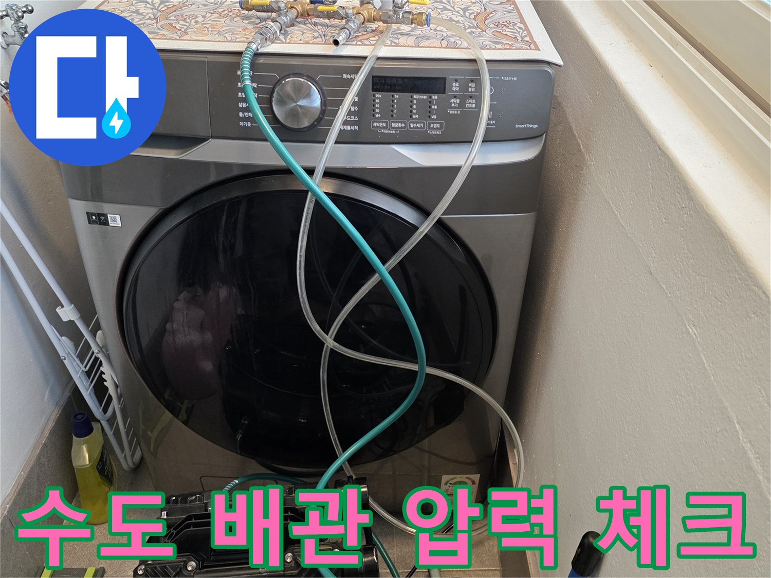 세탁기 수전 부위에 연결된 매니폴드 게이지와 투명 호스