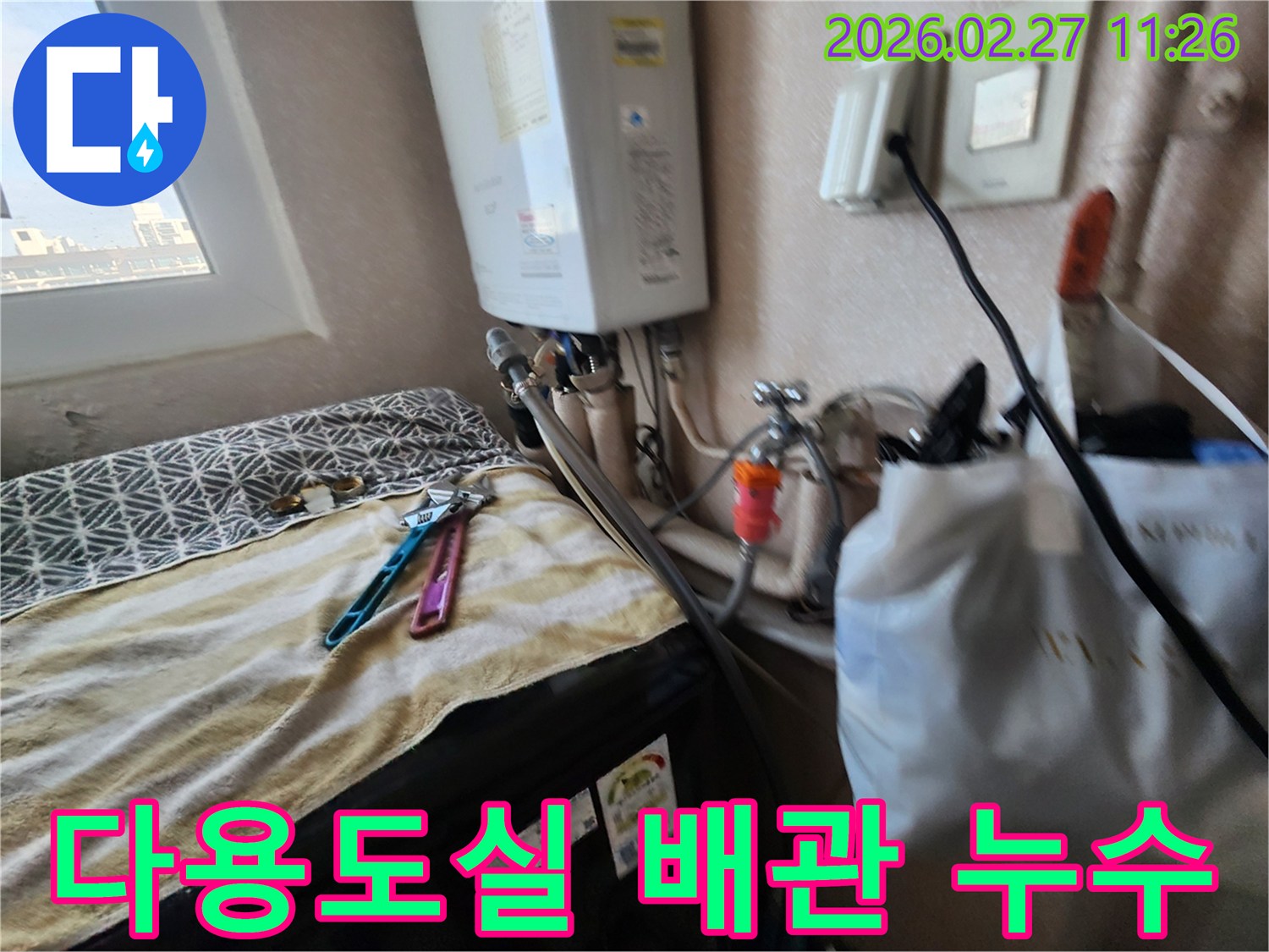 세탁기 옆 보일러 배관에서-발생한 물샘을-해결하기 위한-누수 공사 현장의 한 장면입니다