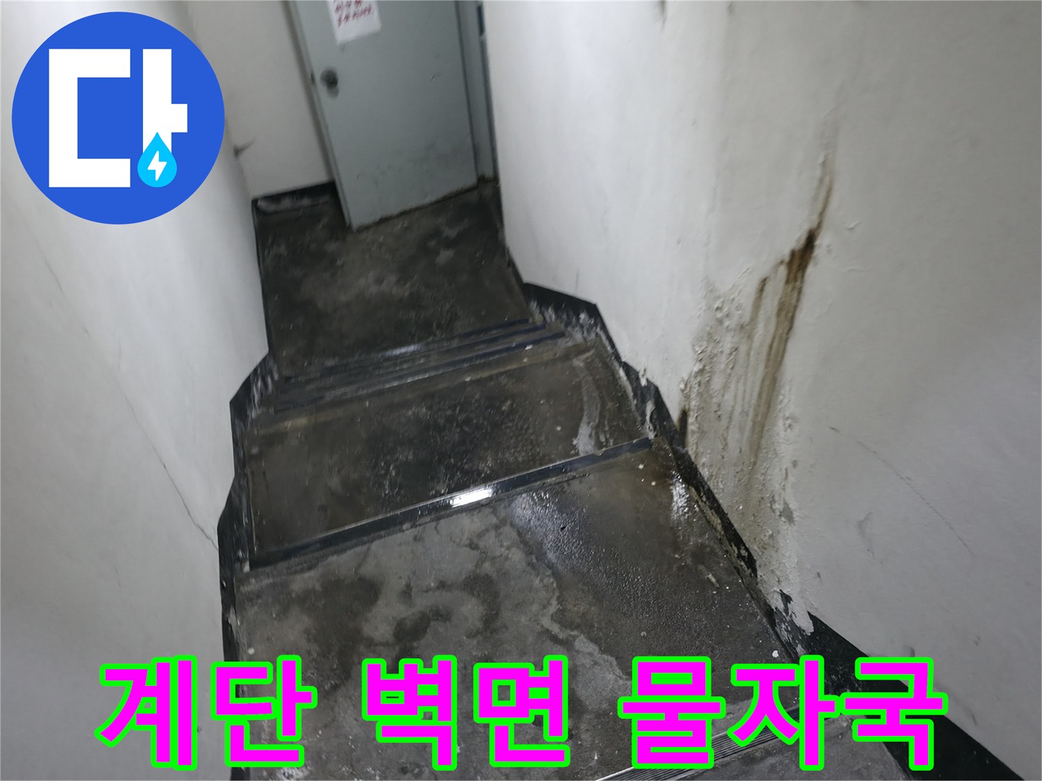 계단 벽면을 따라 발생한 갈색의 누수 오염 자국
