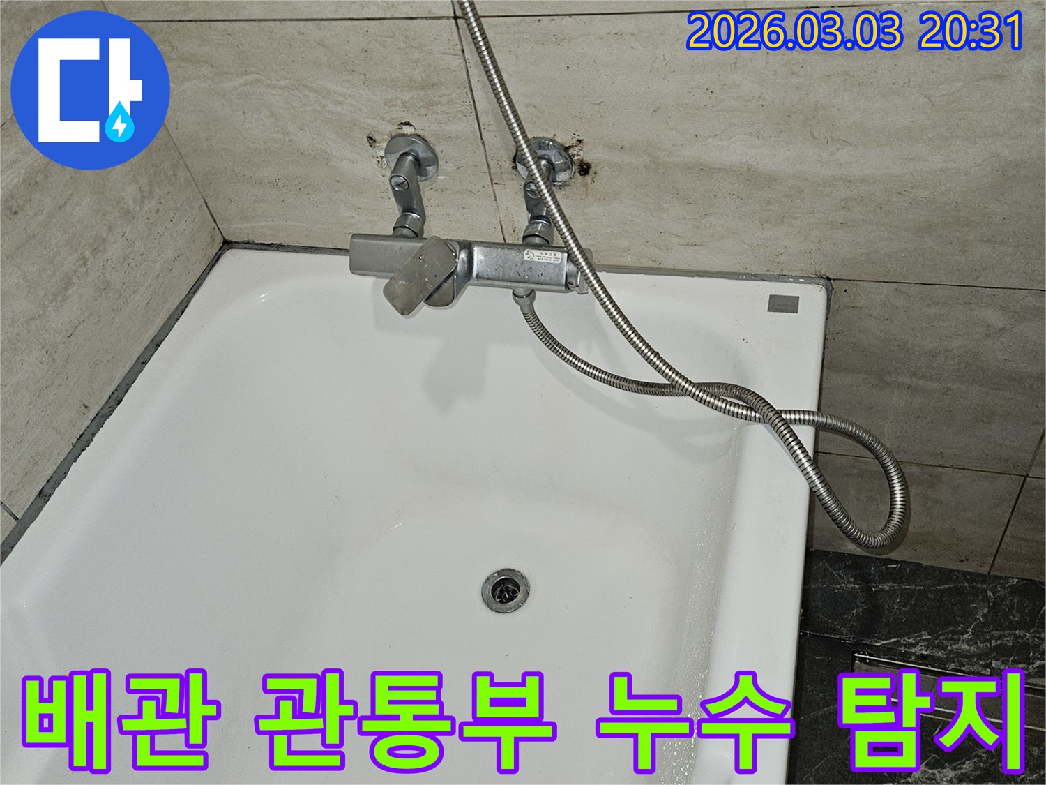 욕조 벽면의-배관 관통부에서-누수가 의심되어-샤워기 수전과-배관 연결 부위를-집중적으로 점검하는-현장 사진입니다