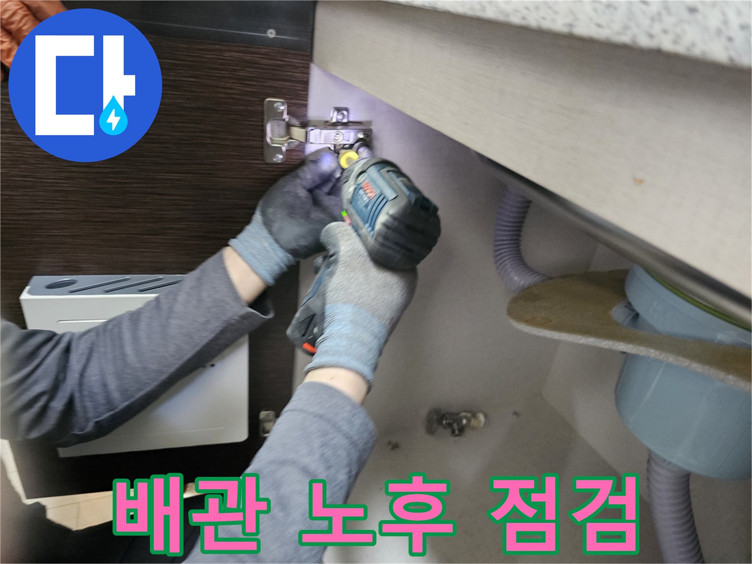누수 전문가가-배관 노후를-점검하기 위해-싱크대 하부장-패널을-분리하는-작업
