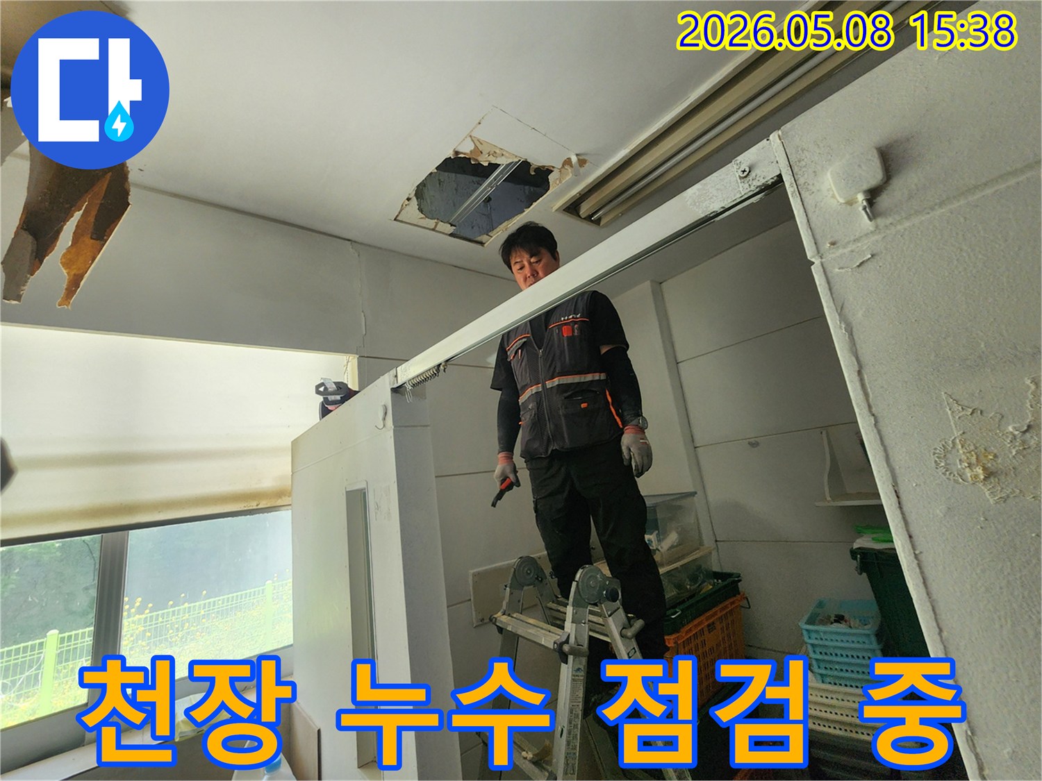 누수 전문가가 사다리 위에서-천장 누수 지점을-세밀하게 검사하고 있습니다