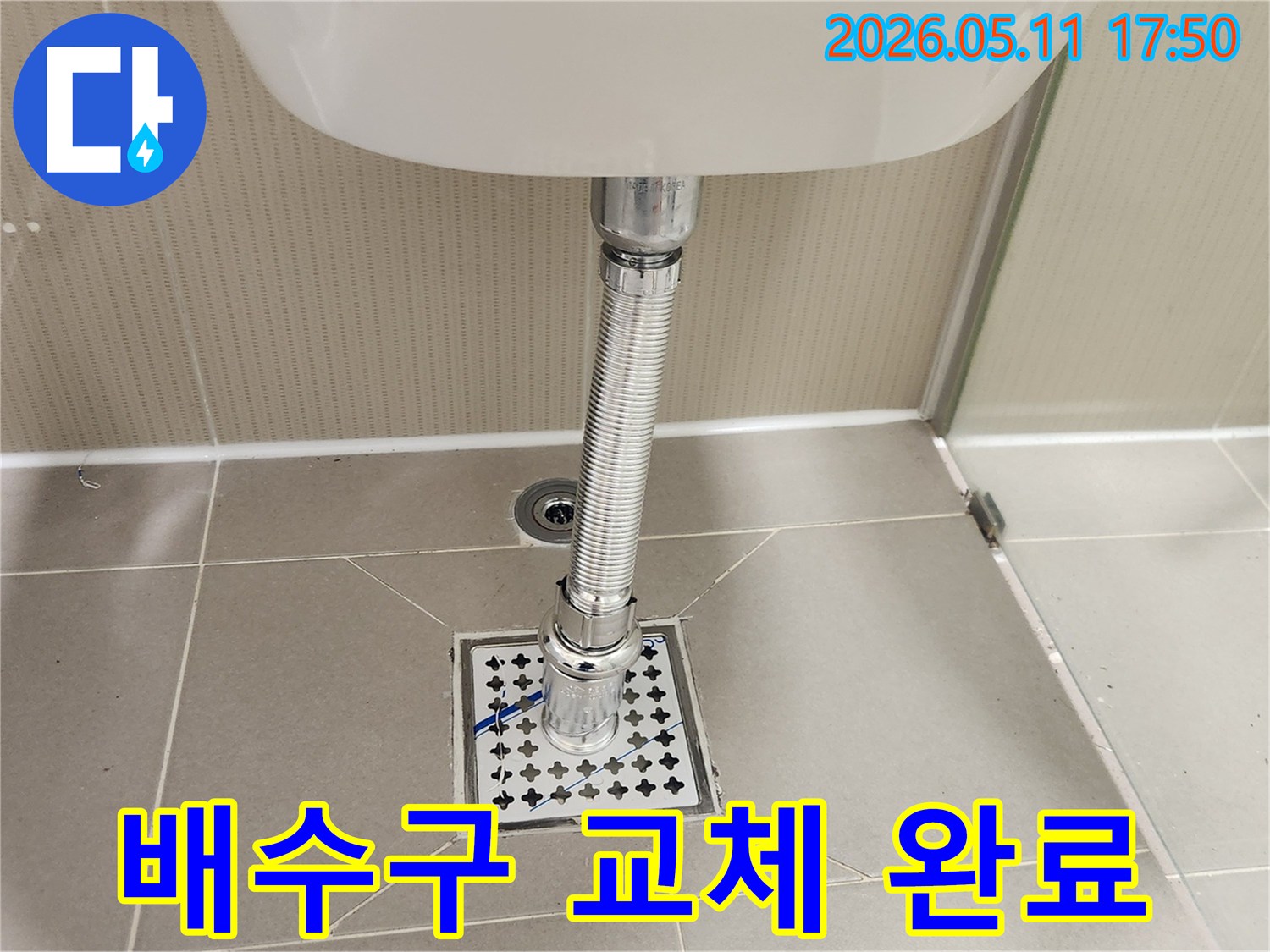 새로운 육가 배수망이-욕실 바닥에-설치되고-세면대 배수관과-완벽하게 연결된-시공 후의-깨끗한 모습입니다.
