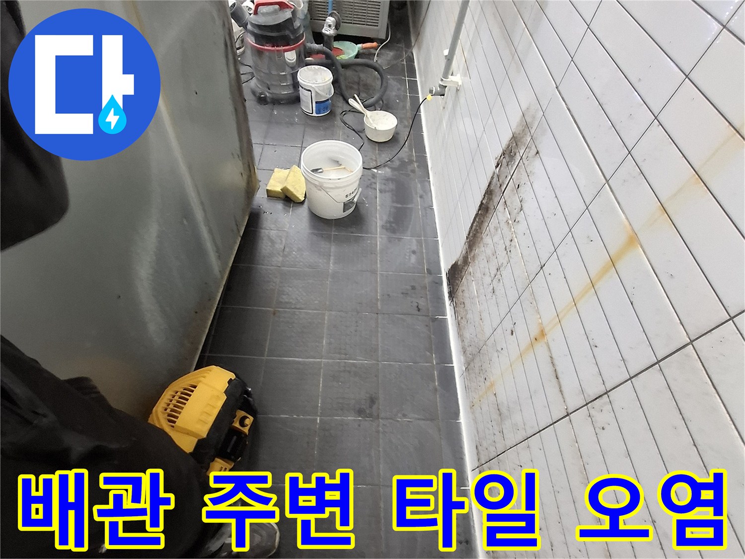 하얀색 벽 타일 하단부의 누런 변색과 습기 머금은 상태
