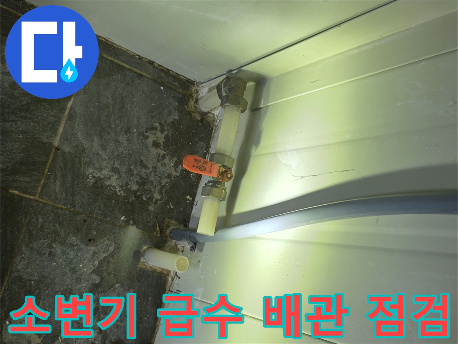 벽면 배관과 소변기 밸브 연결 부위의 누수 흔적