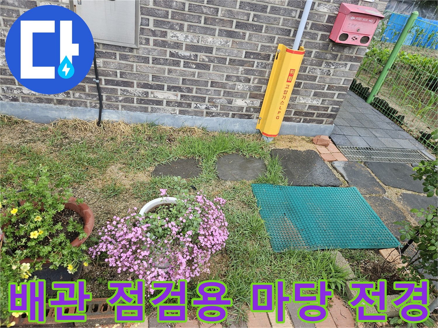 외부 수도 시설과-주변 화단 및 벽돌 외벽의 모습
