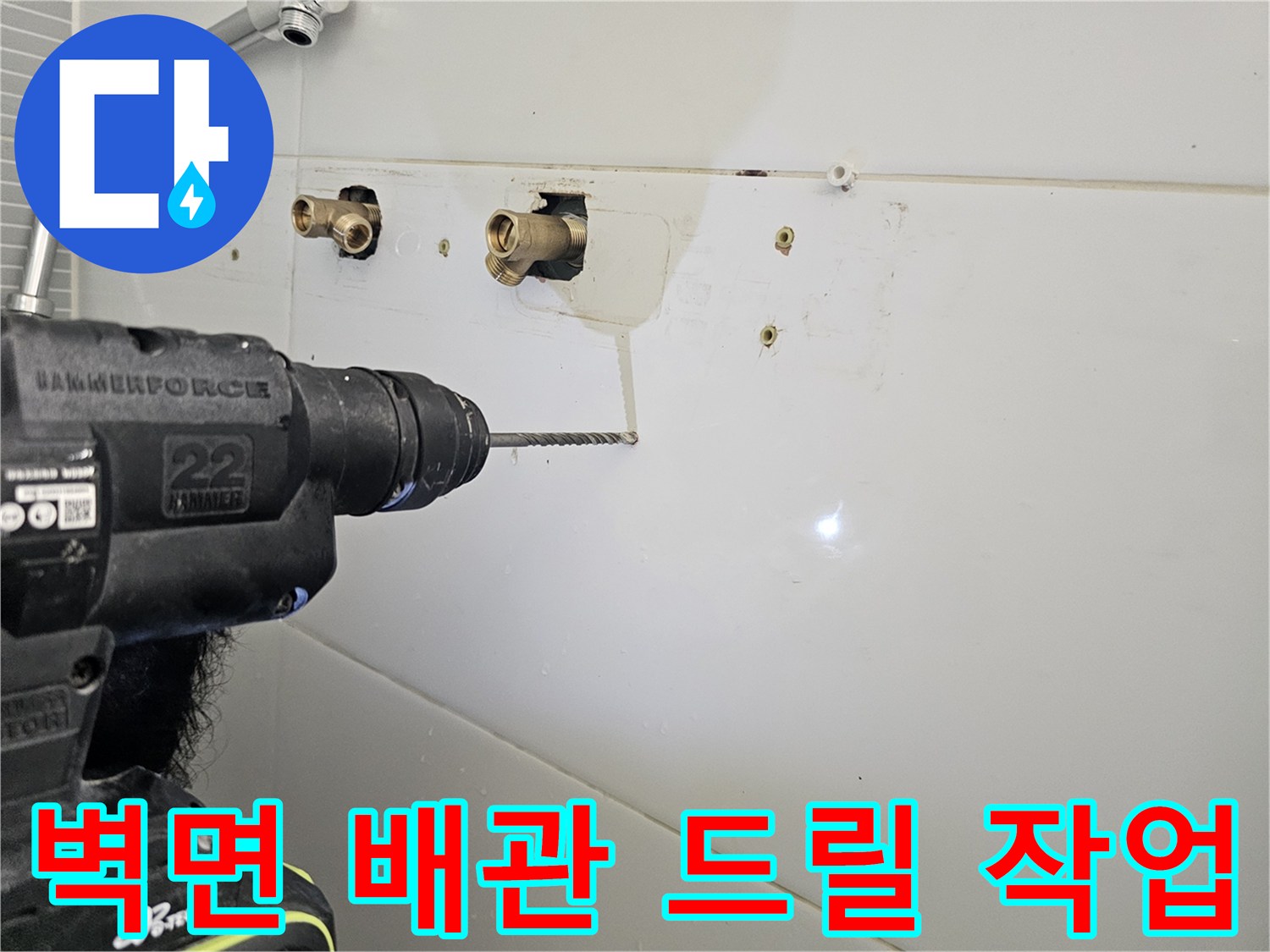 화장실 벽면-노출된 수전 배관과 전동 드릴 사용 모습