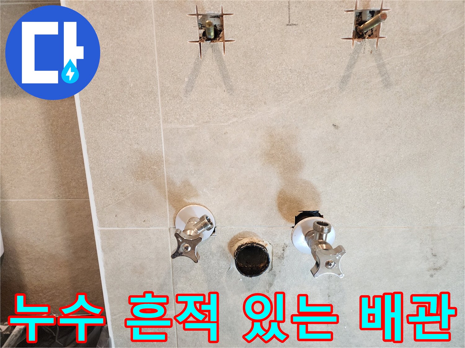 물기가 스며든-벽면 타일과-노출된 수도 부품들