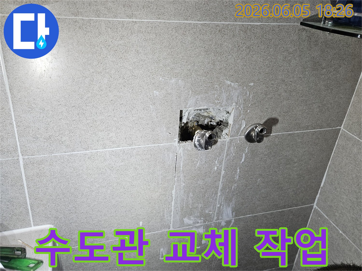 욕실 벽면 내부에서 누수가 발생한 수도관을-새로운 자재로 교체하는 전문적인 작업 현장