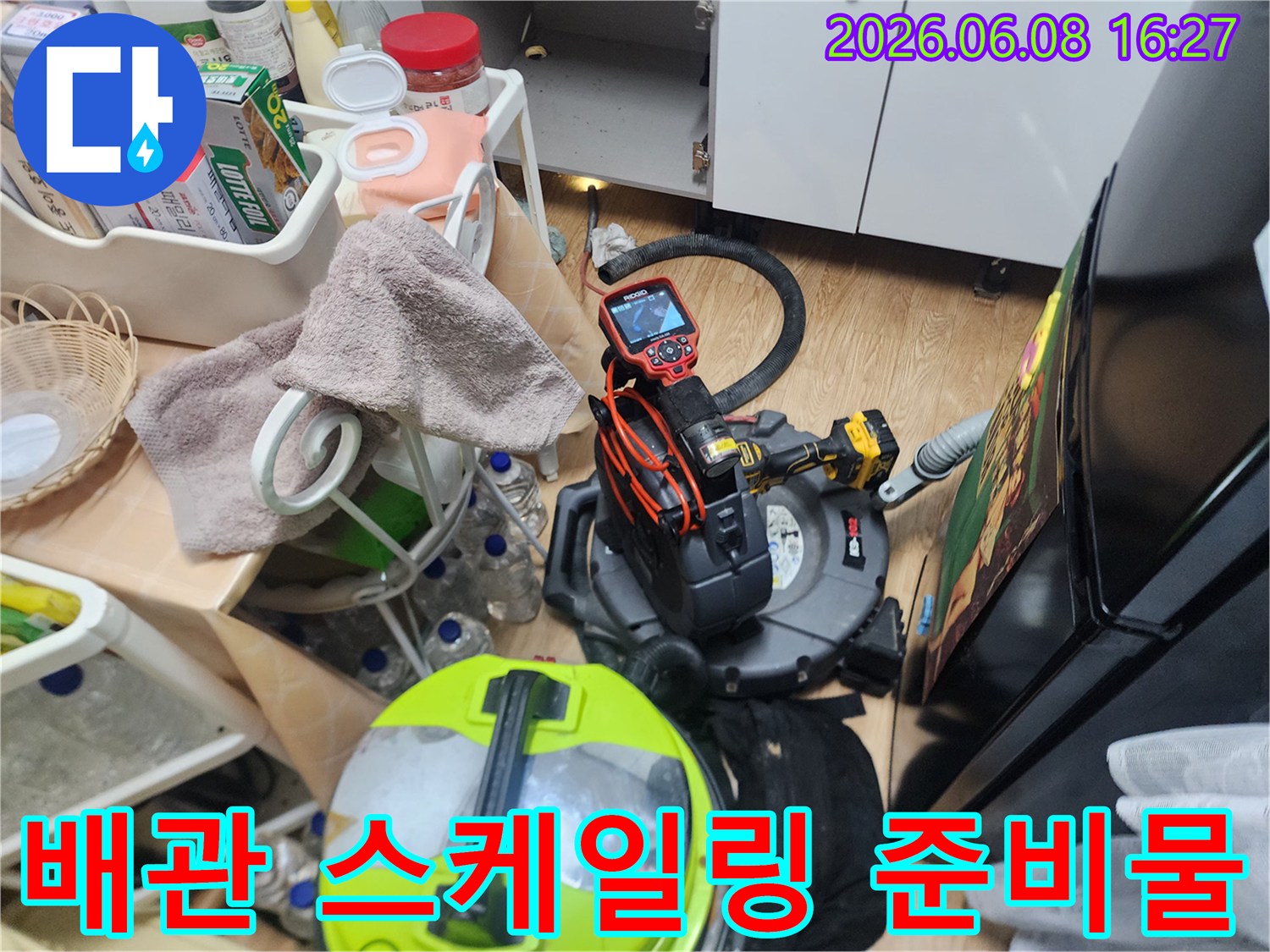 배관 내부 청소를 위해 싱크대 하단에 배치된 전문 장비 세트