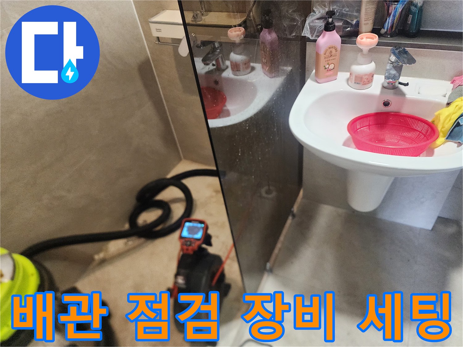 세면대 아래 바닥에 배치된 배관 내시경 모니터와 흡입 장비