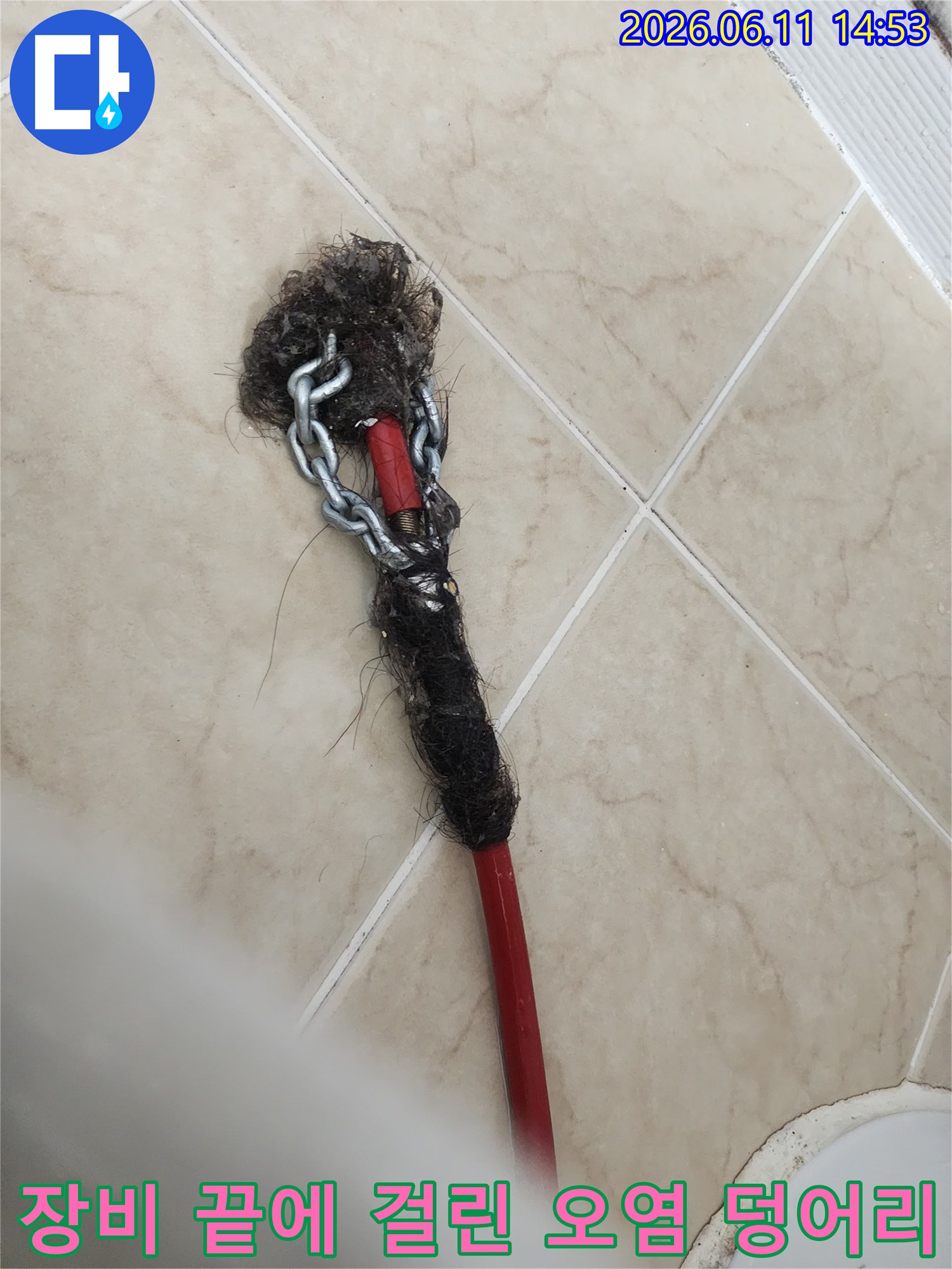 붉은색 막대와 체인에 걸려 올라온 머리카락 슬러지 뭉치