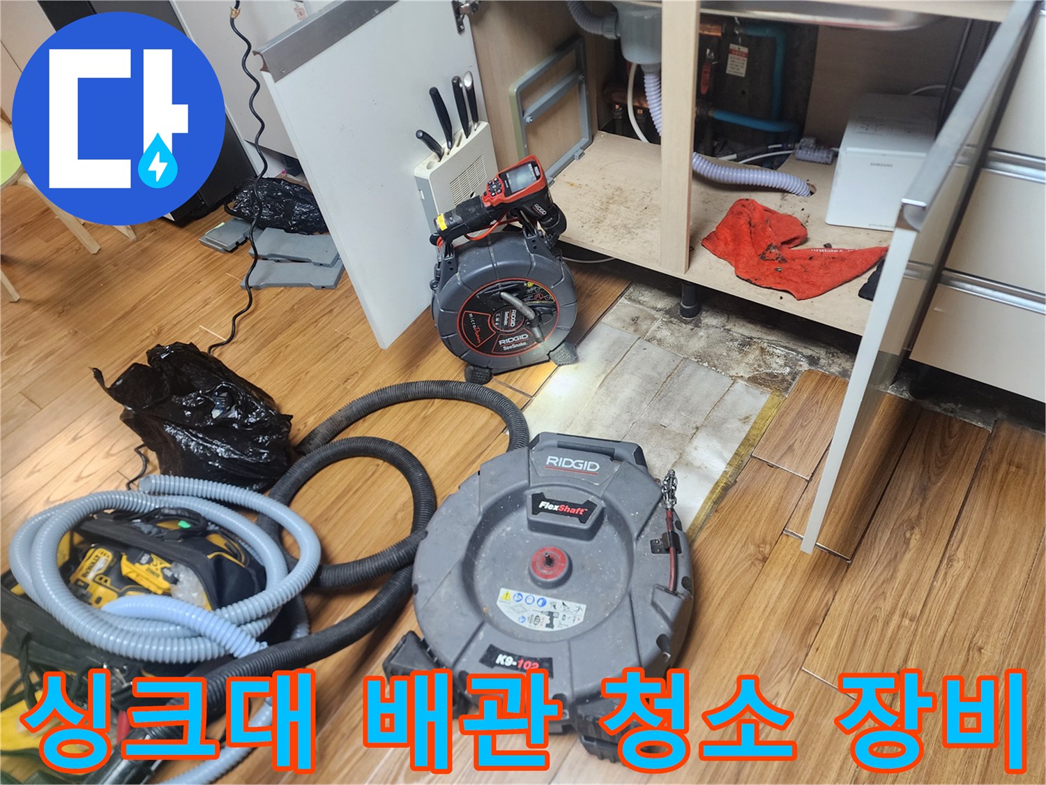 주방 싱크대 하부 배관 작업을 위해 배치된 스케일링 및 석션 장비 세팅