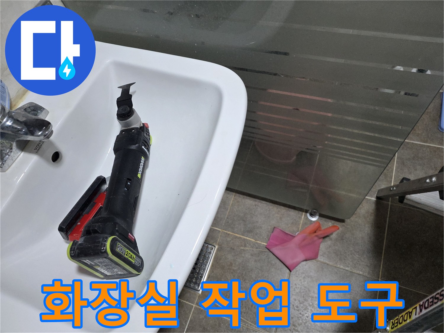 세면대 옆에 놓인 전동 드릴과 분홍색 장갑