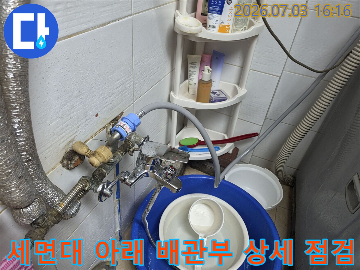 세면대 밑에 노출된 수도 배관의 연결 부위와 밸브 상태 확인