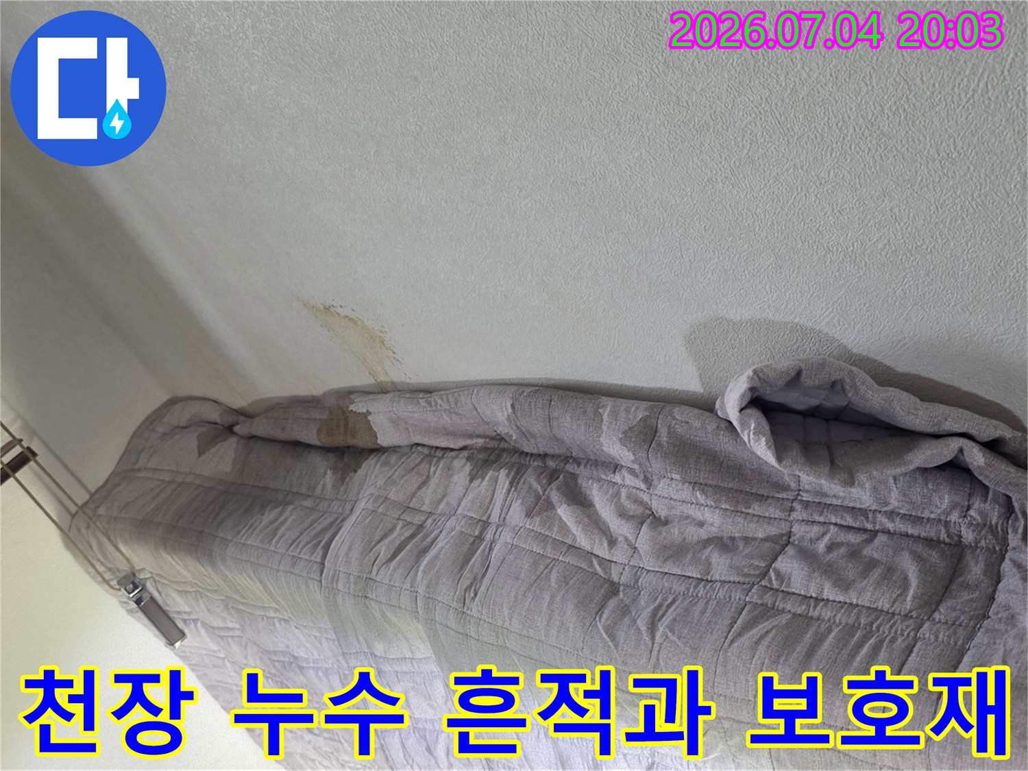 누수가 발생한 천장 부위와 임시로 덮어놓은 보양용 자재