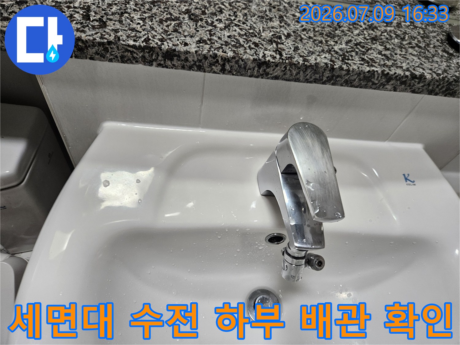화이트 세면대 아래 위치한 금속성 수전과 연결 배관 점검