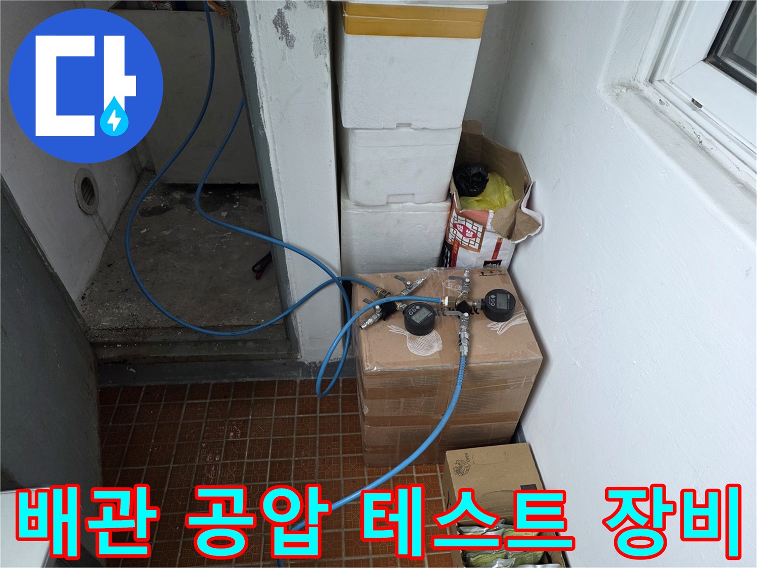 푸른색 호스가 연결된-배관 압력 측정 장비의 모습
