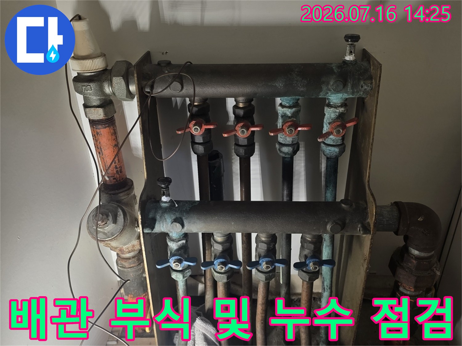 부식된 금속 분배기와 여러 갈래의 배관 연결부