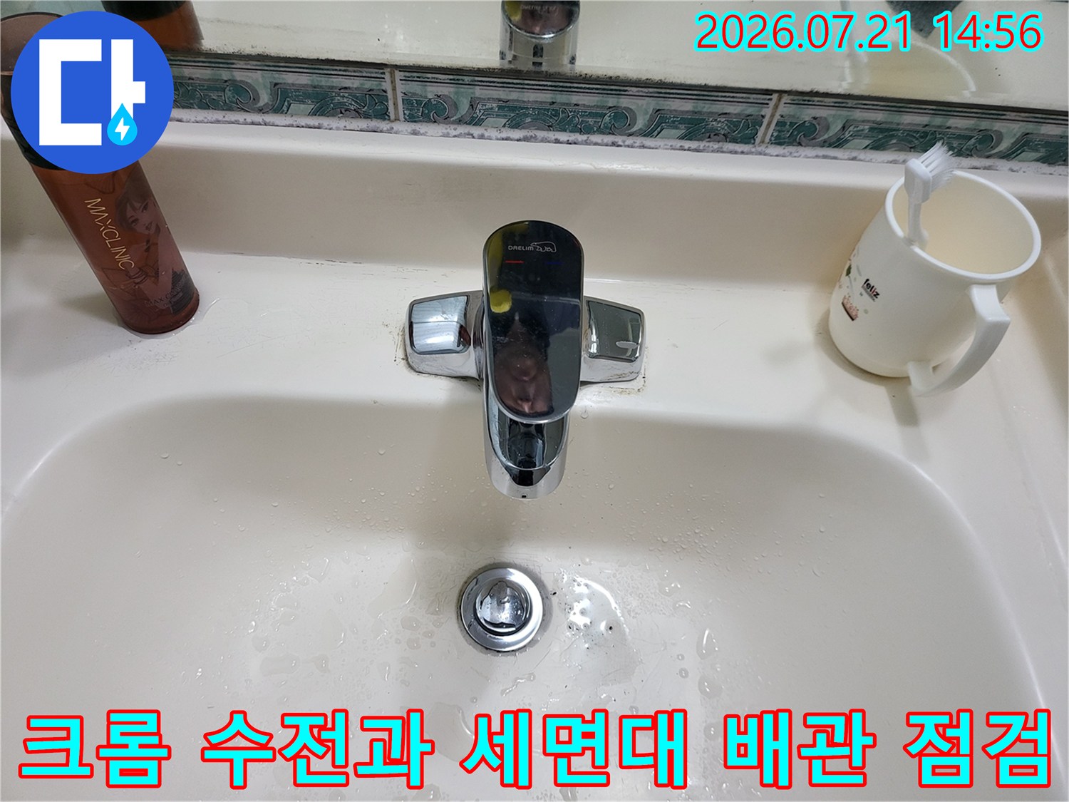 세면대에 설치된 크롬 마감의 수도꼭지와 배관 연결부