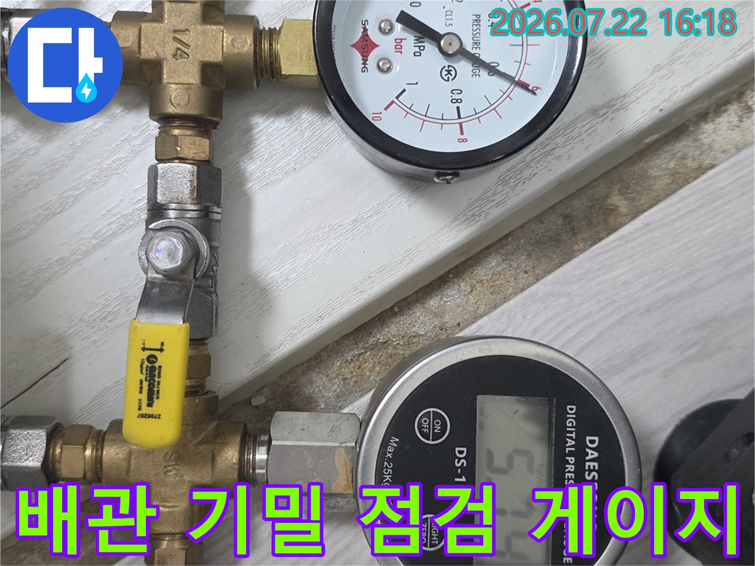 금속 밸브와 호스가 연결되어 압력을 측정하고 있는 누수 진단 장비 사진