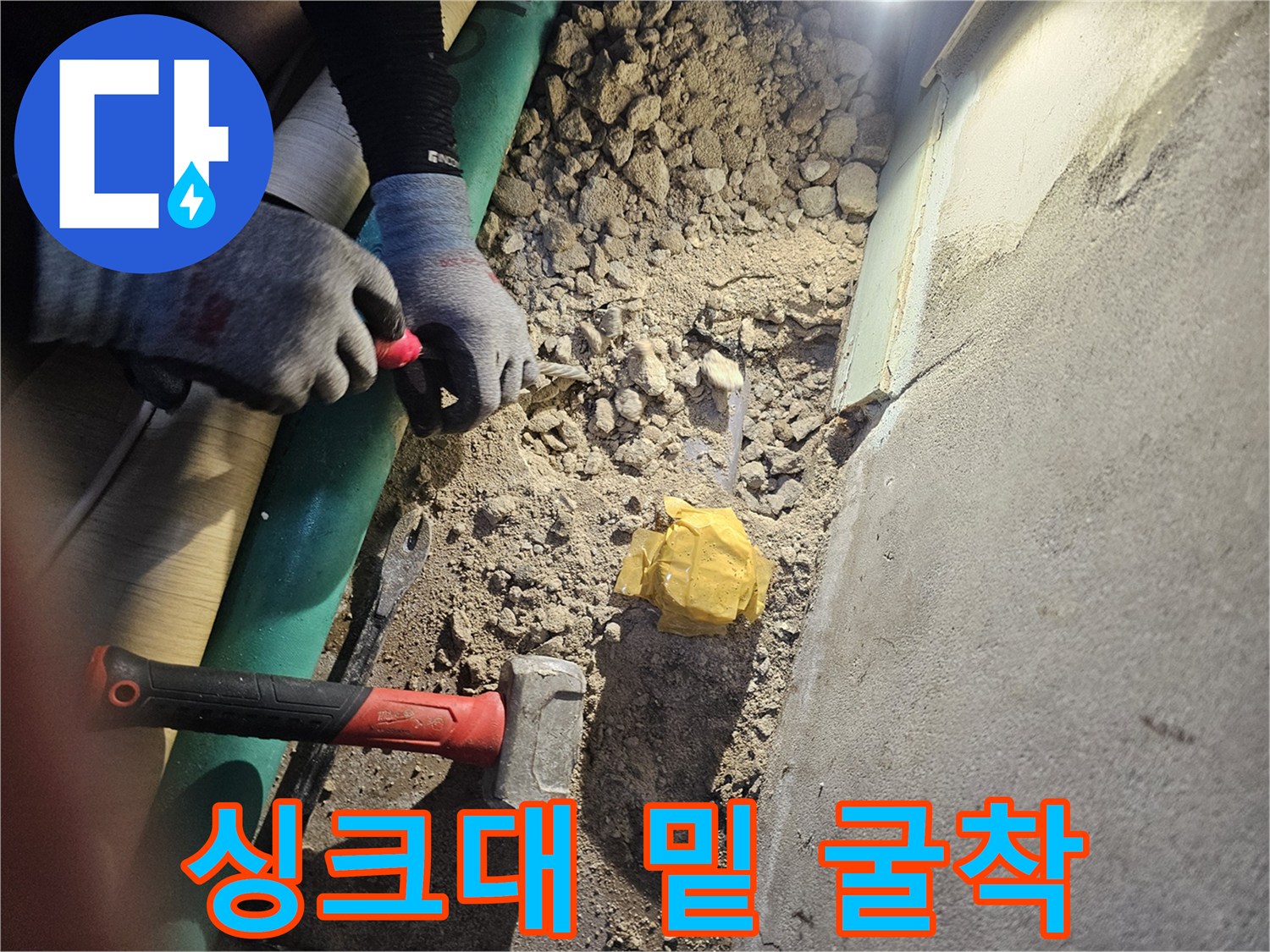 주방 싱크대 아래쪽 바닥 타일을 제거한 작업 현장 사진