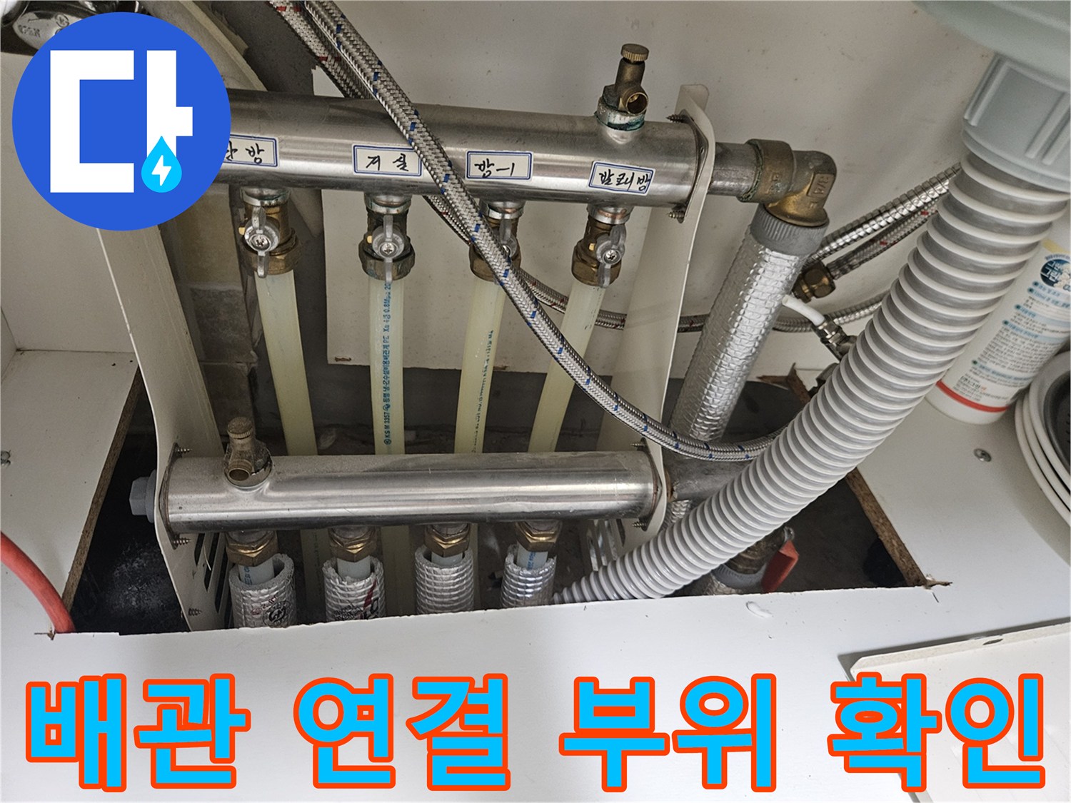 싱크대 하단에 위치한 여러 갈래의 급수 및 배수 배관들
