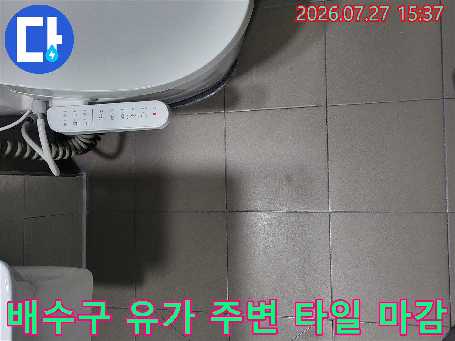흰색 세면대와 비데 사이 바닥에 위치한 배수구-유가 사진