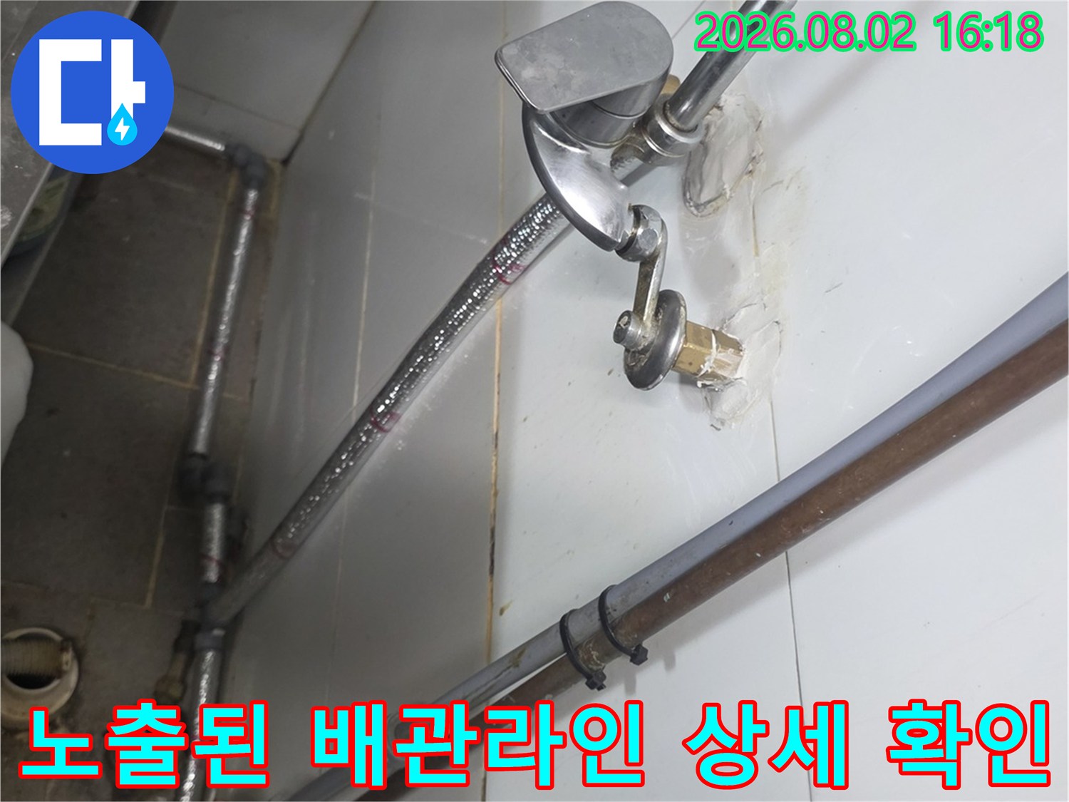 은색 금속 재질의 굴곡형 수도 배관과 연결 부위 점검 모습
