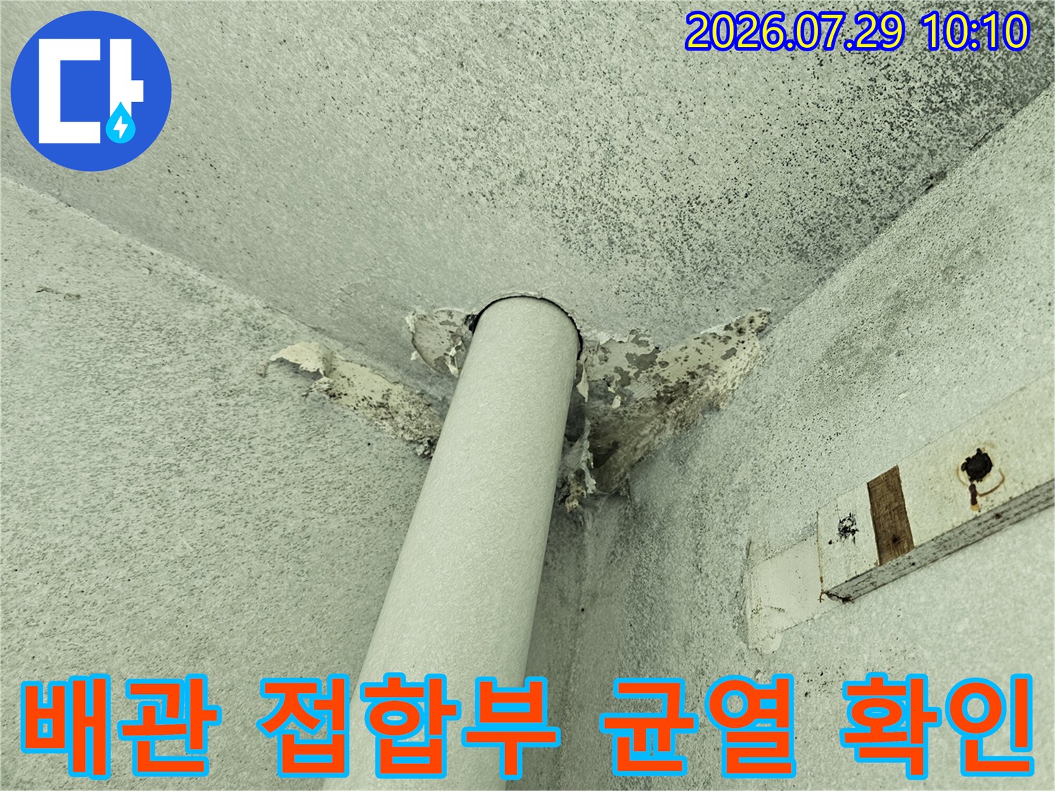 우수관 주변 마감재가 훼손되어 노출된 배관 연결 부위