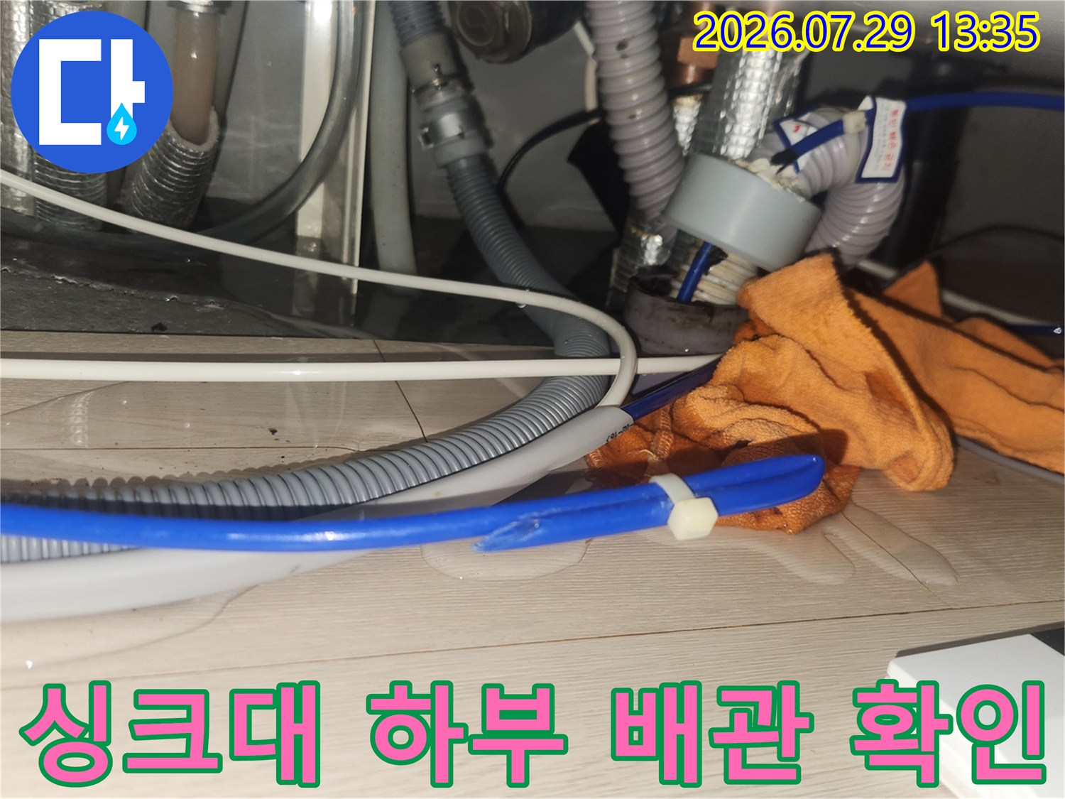장비를 활용하여 싱크대 밑 배수 라인을 점검하는 현장