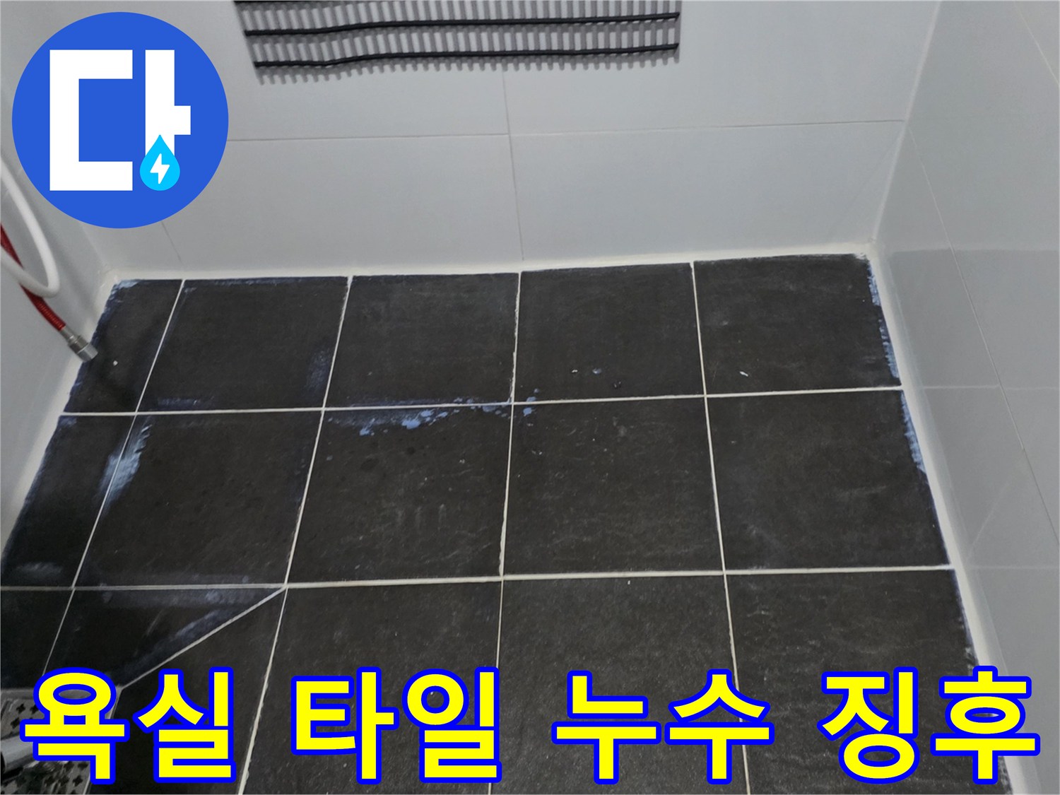 물기가 스며든 듯한 어두운색 욕실 타일