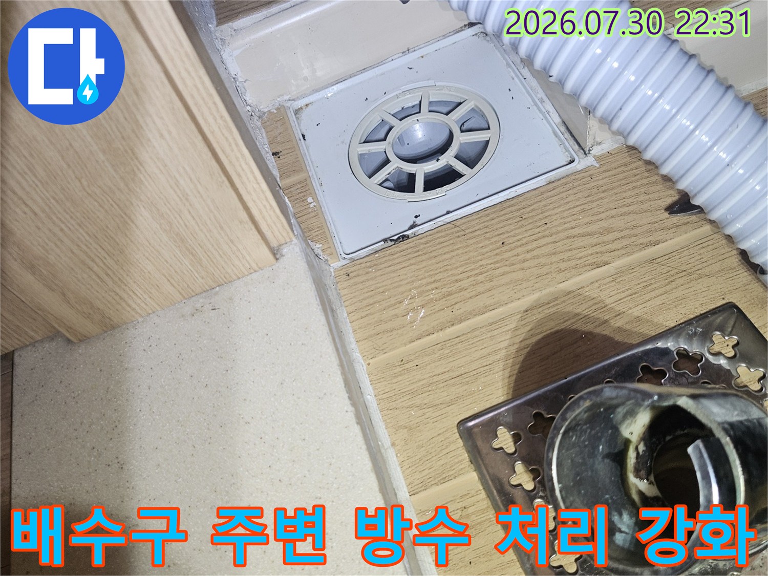 하얀색 배수 호스와 바닥 유가 결합 부위의 상세 모습