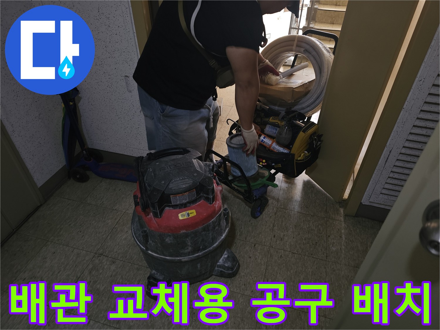 욕조 하부 배관 작업을 위해 바닥에 놓인 각종 전문 장비와 청소기