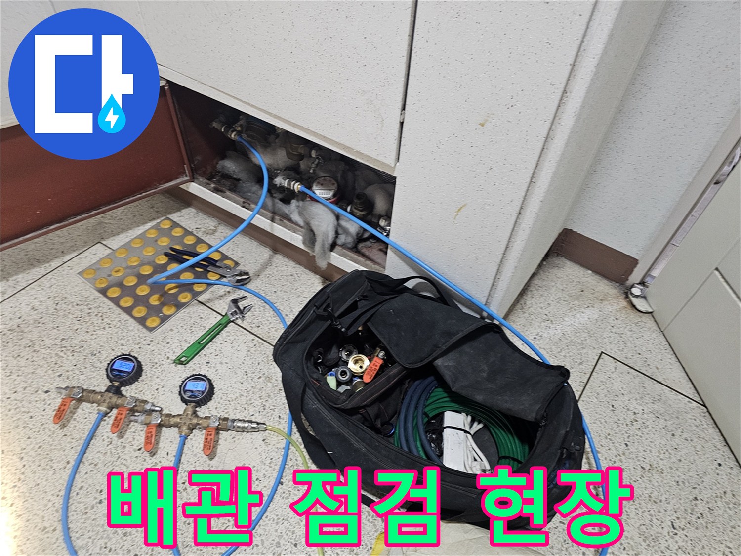 점검구 안쪽의 배관 구조와 압력 측정 장비들